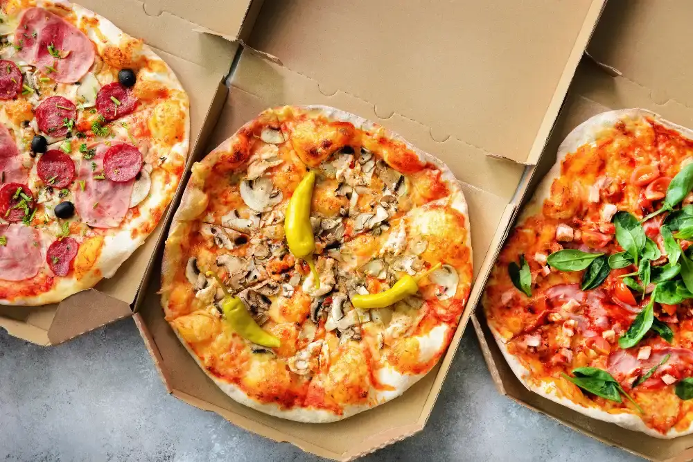 a group of pizzas in boxes